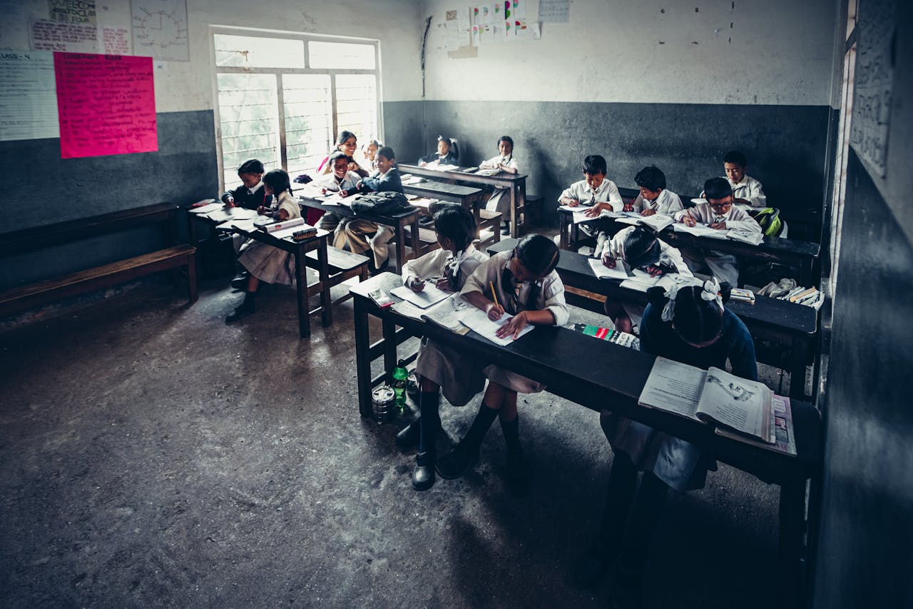 Students engaged in focused learning inside a primary school classroom. Education in action.