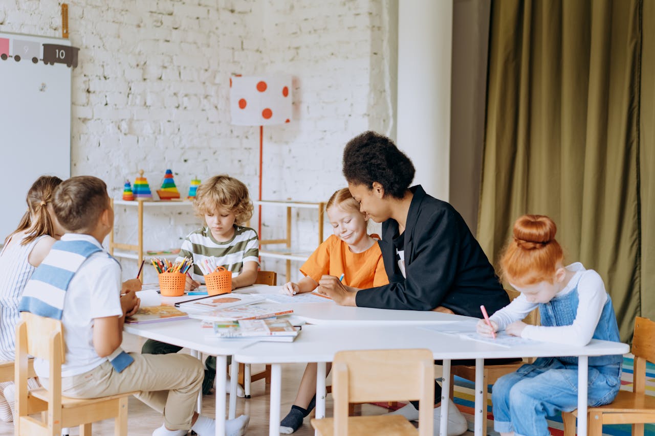 A teacher engaging with diverse children during a classroom activity, promoting education and learning.